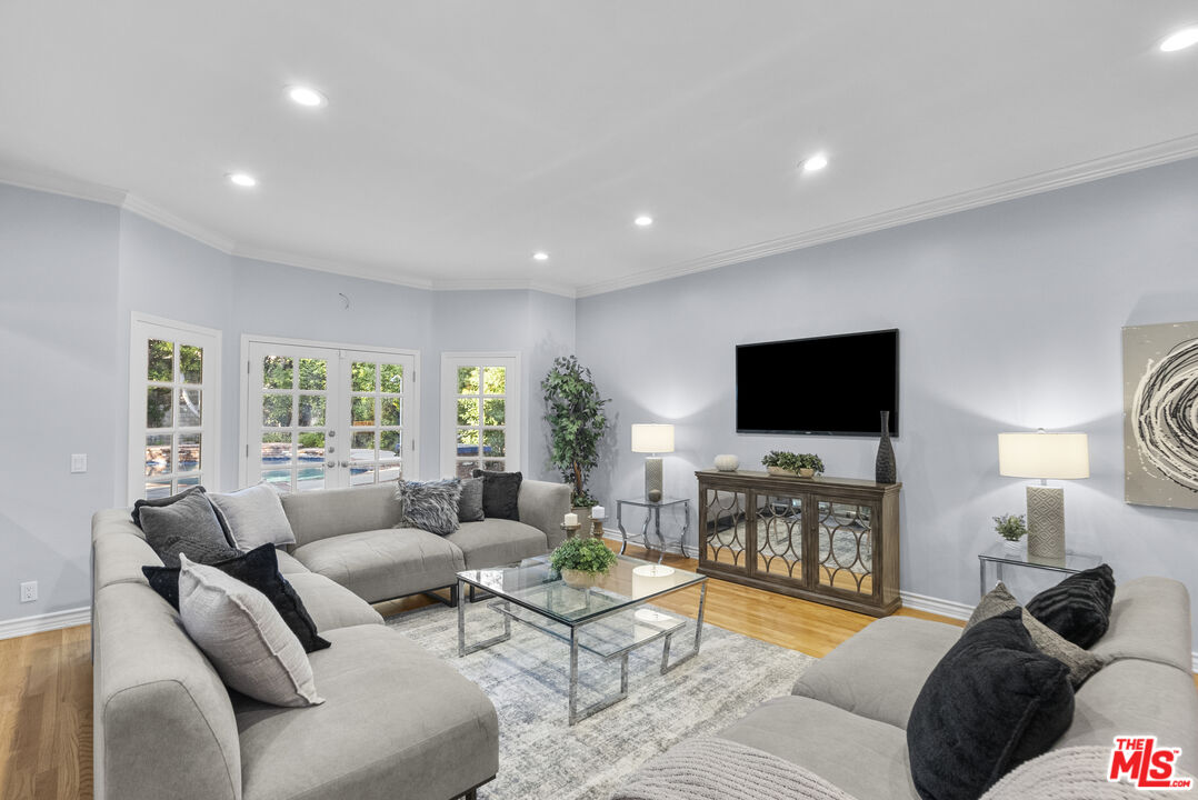 18779 Willowtree Lane Porter Ranch, CA 91326 - Photo 7 of 63 a living room with furniture and a flat screen tv
