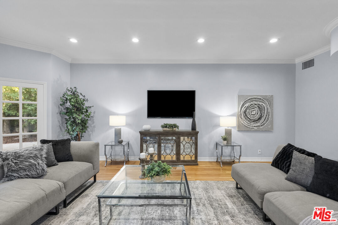 18779 Willowtree Lane Porter Ranch, CA 91326 - Photo 8 of 63 a living room with furniture and a flat screen tv