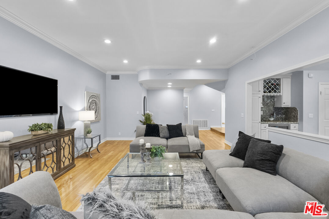 18779 Willowtree Lane Porter Ranch, CA 91326 - Photo 9 of 63 a living room with furniture and a flat screen tv