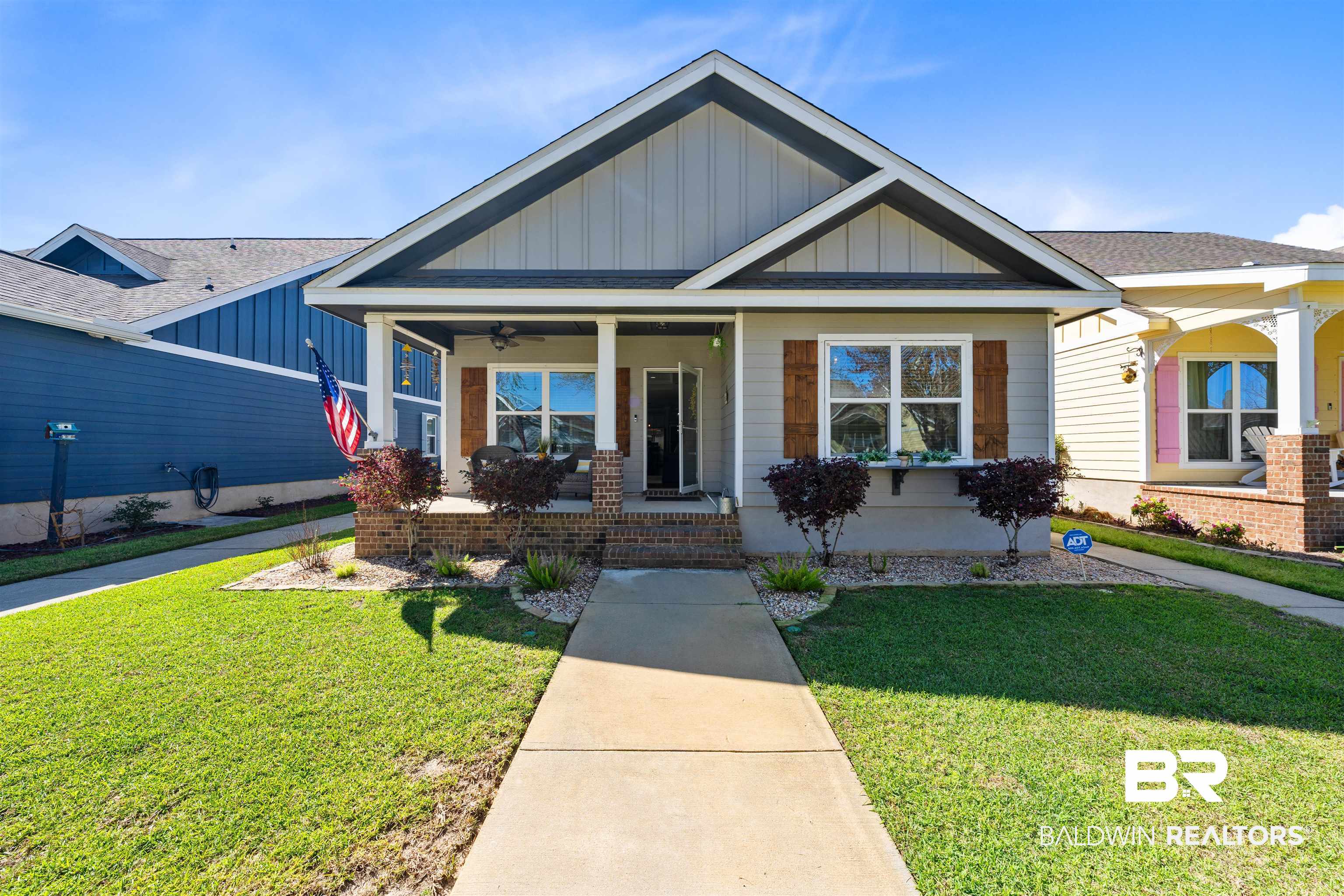 1221 Primrose Lane Foley, AL 36535 - Photo 2 of 29 Craftsman house with brick siding, board and batten siding, a porch, and a front lawn