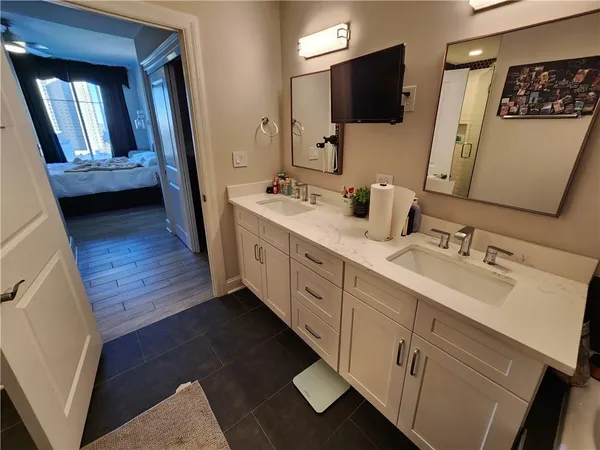 a bathroom with a double vanity sink and mirror