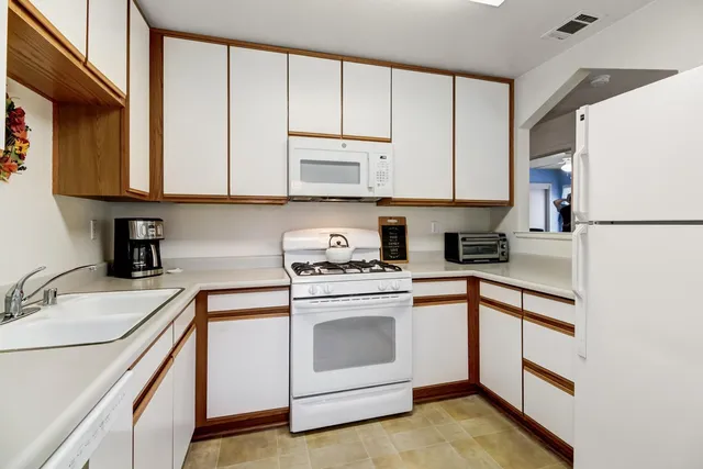 a backyard of a house with lots of green space and fountain