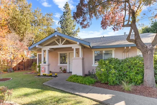 a living room with furniture a large window and a chandelier