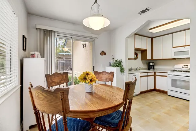 a front view of a house with a yard garage and outdoor seating