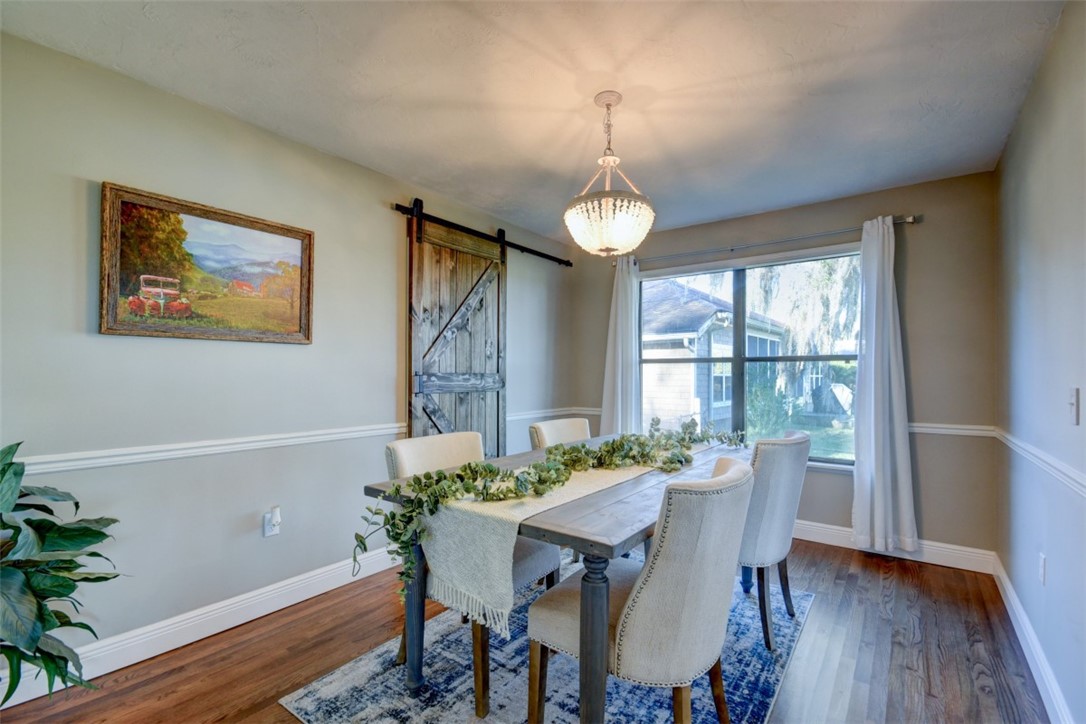 97260 Pirates Point Road Yulee, FL 32097 - Photo 6 of 23 a view of a dining room with furniture wooden floor and chandelier