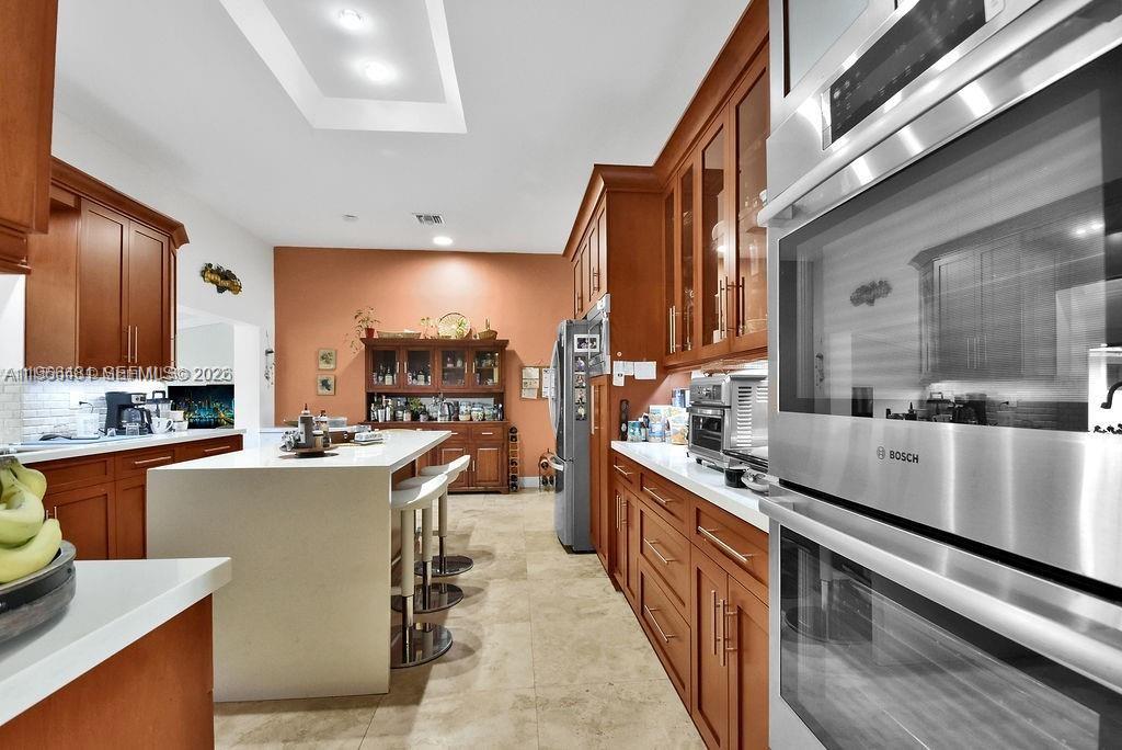 5425 Southwest 190th Avenue, Unit 1 Southwest Ranches, FL 33332 - Photo 8 of 56 a kitchen with stainless steel appliances a sink a stove top oven a counter space and cabinets
