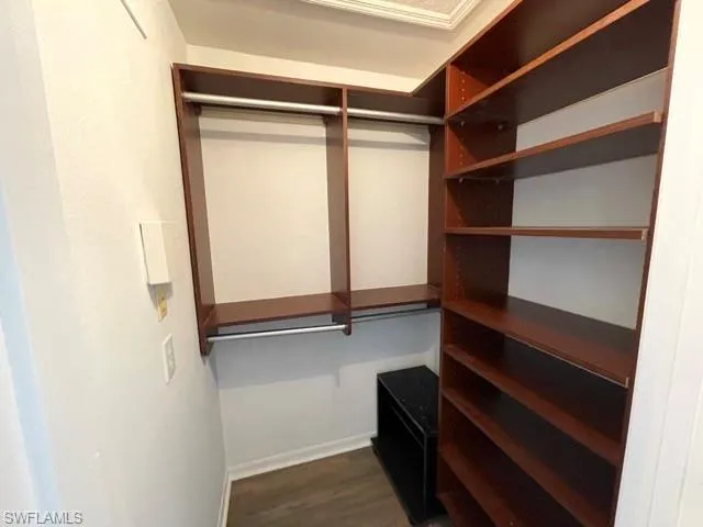 a view of walk in closet with empty racks