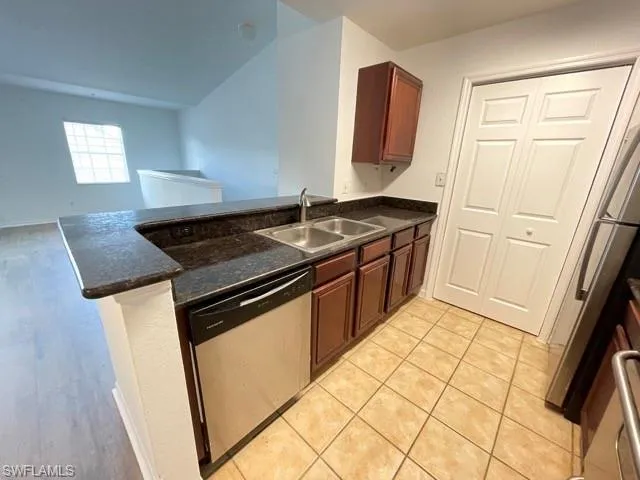 a kitchen with granite countertop a sink stove and cabinets