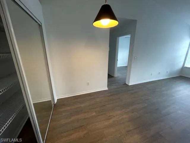 wooden floor in an empty room with a mirror