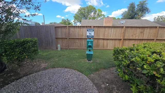 a view of a backyard with a fence
