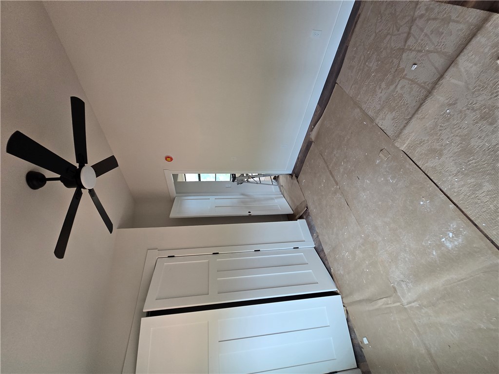 157 Hunting Hollow Road Six Mile, SC 29682 - Photo 9 of 19 A striking black ceiling fan contrasts with clean white walls in this space, ready for final touches.