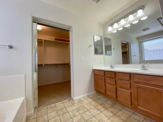 a bathroom with a double vanity sink and a mirror