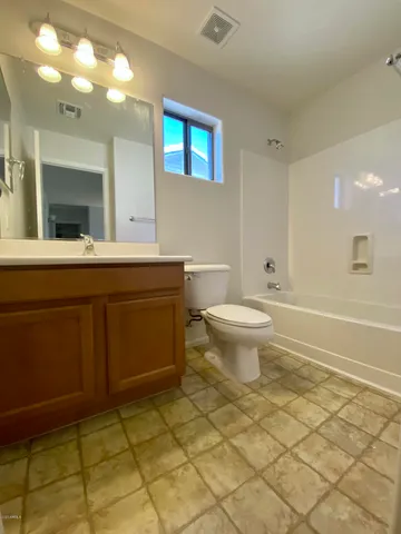 a bathroom with a sink toilet and a mirror