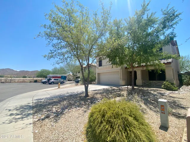 a view of a house with a yard and mountain view
