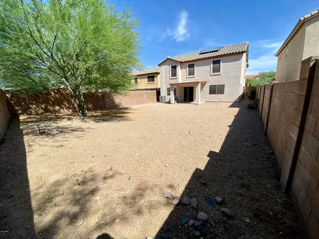 a view of a house with wooden fence