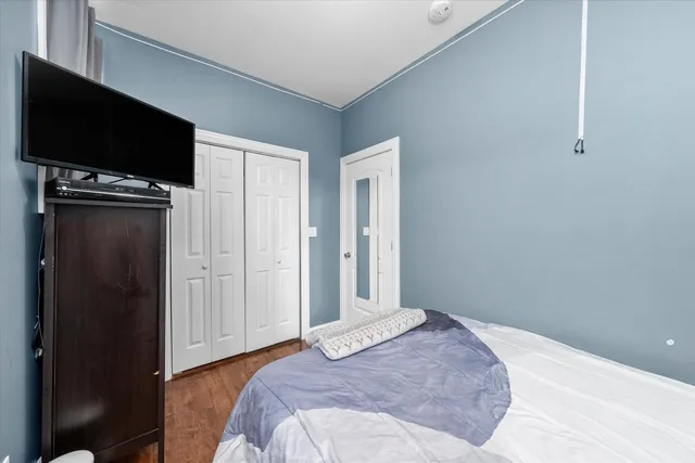 a bedroom with a bed and a flat screen tv