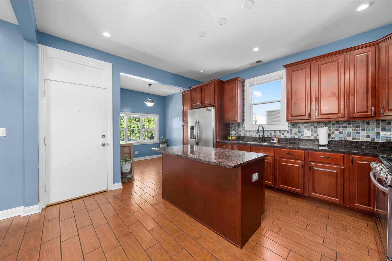 5108 West 24th Place, Unit 2 Cicero, IL 60804 - Photo 13 of 29 a kitchen with stainless steel appliances granite countertop a refrigerator a sink dishwasher a stove with wooden cabinets and floor