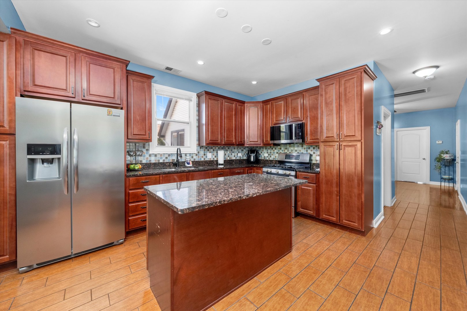 5108 West 24th Place, Unit 2 Cicero, IL 60804 - Photo 14 of 29 a kitchen with stainless steel appliances granite countertop a refrigerator a sink dishwasher a stove with wooden cabinets and a refrigerator