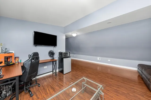 a view of a workspace with furniture and a flat screen tv