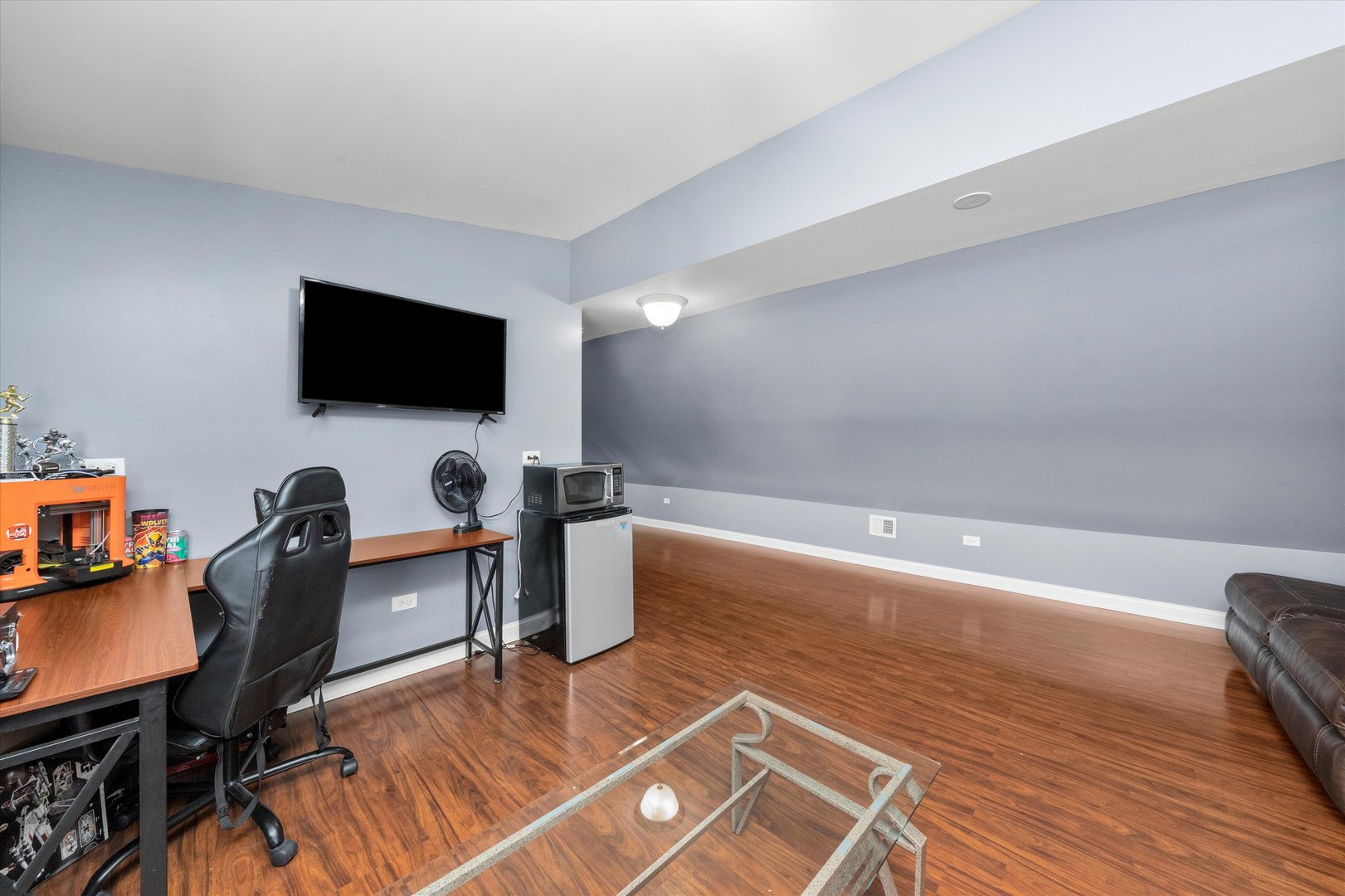 5108 West 24th Place, Unit 2 Cicero, IL 60804 - Photo 20 of 29 a view of a workspace with furniture and a flat screen tv