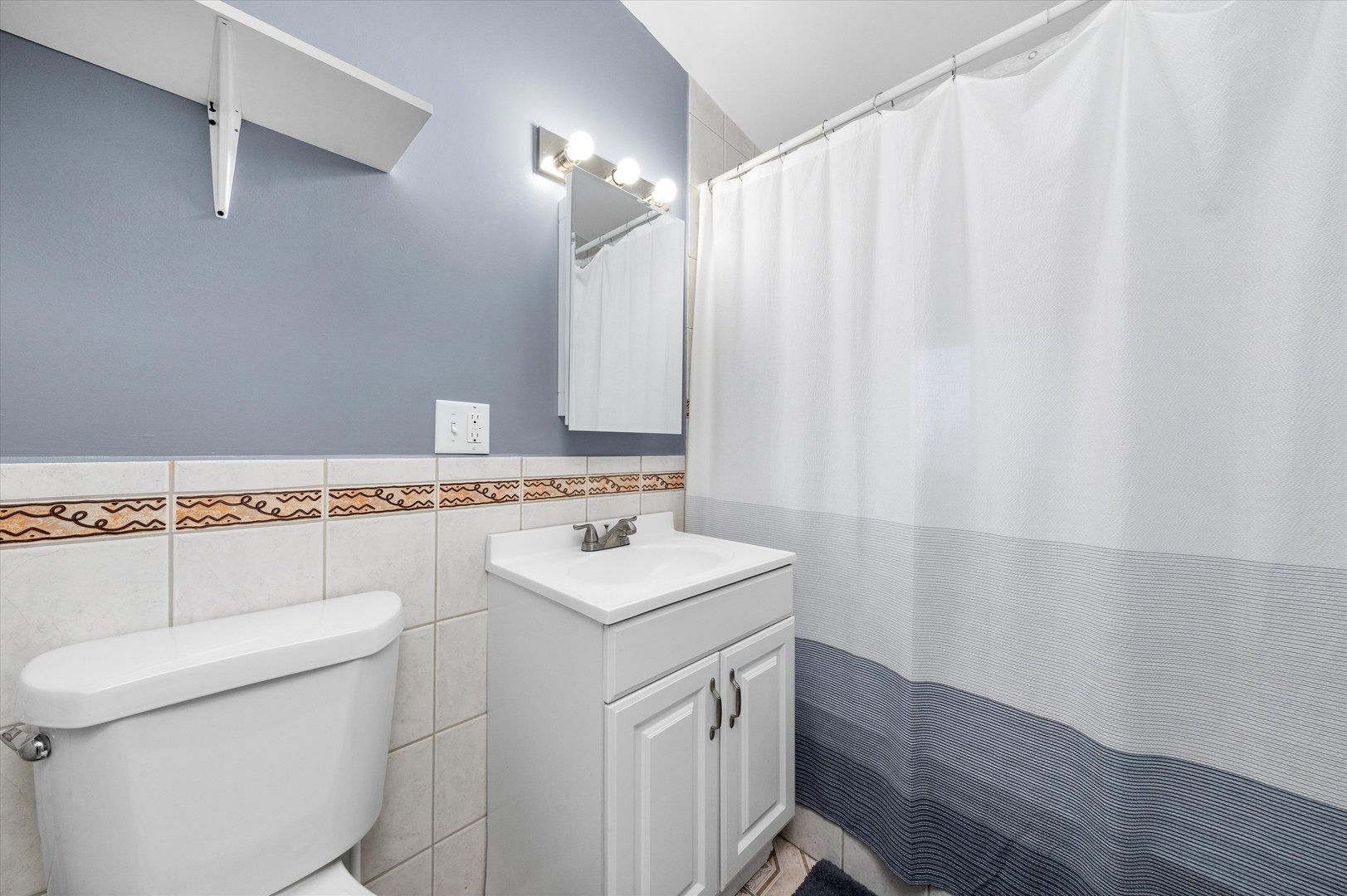5108 West 24th Place, Unit 2 Cicero, IL 60804 - Photo 23 of 29 a bathroom with a sink a toilet and shower
