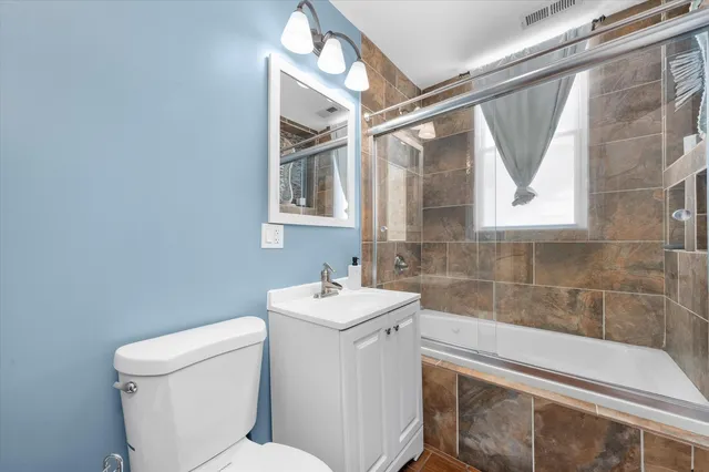 a bathroom with a sink toilet and mirror