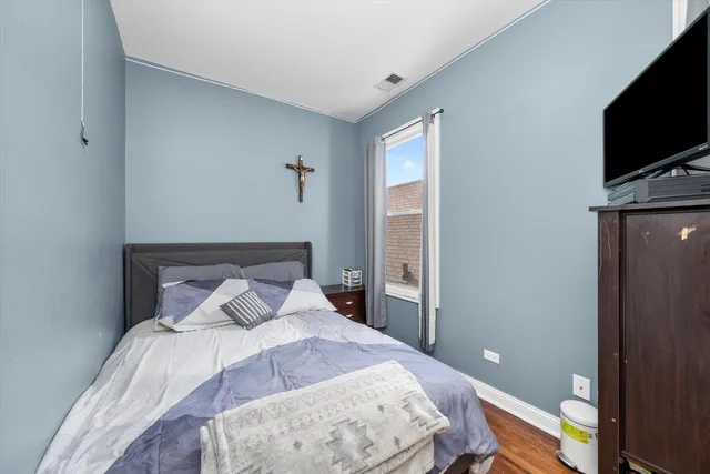 a bedroom with a bed and a flat screen tv