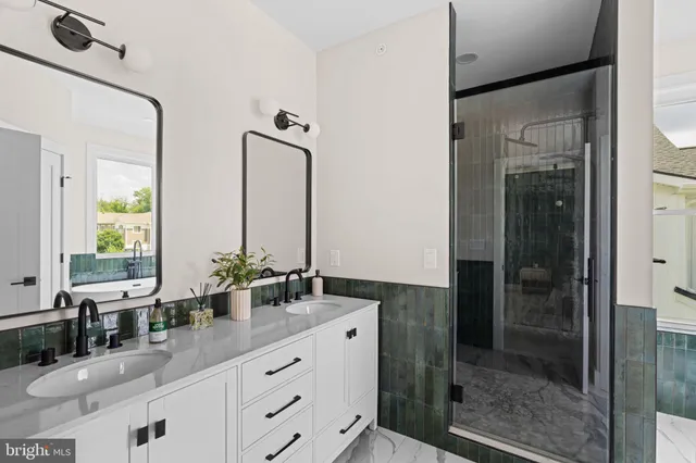 a bathroom with a double vanity sink and mirror