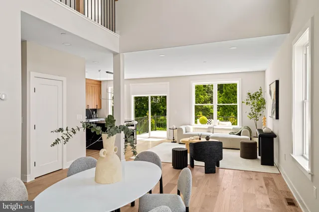 a living room with furniture and large windows