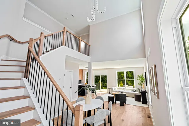 a dinning room with wooden floor and windows