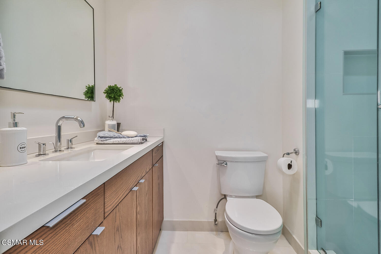 844 16th Street, Unit 5 Santa Monica, CA 90403 - Photo 23 of 31 a bathroom with a toilet sink and mirror