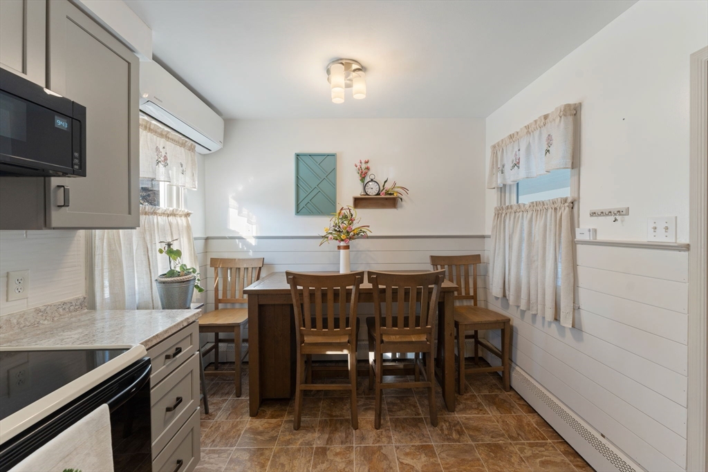 8 Taft Street Uxbridge, MA 01569 - Photo 13 of 31 a kitchen with a dining table chairs and a stove