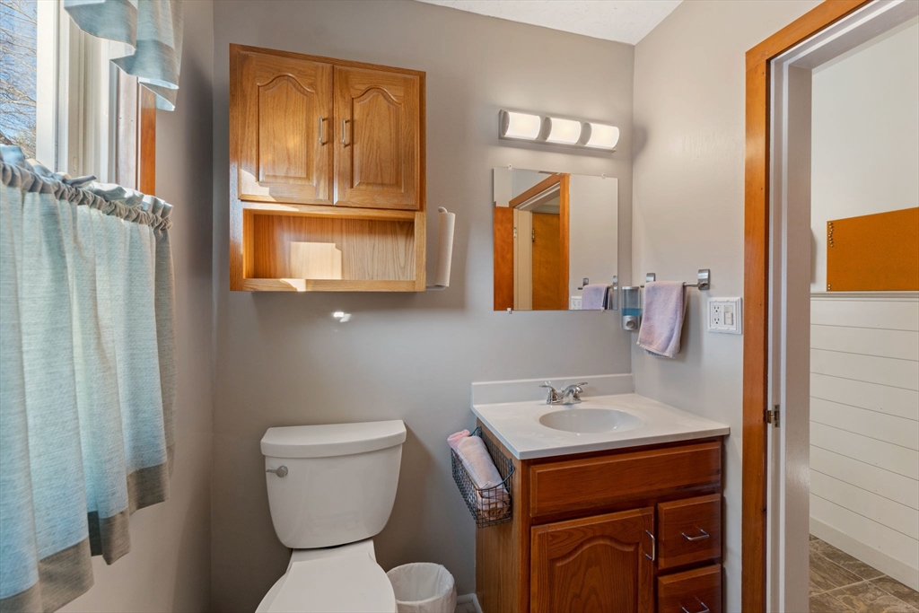 8 Taft Street Uxbridge, MA 01569 - Photo 17 of 31 a bathroom with a sink a toilet and a mirror