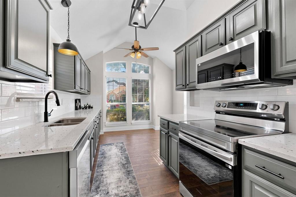 2601 Daisy Lane Rowlett, TX 75089 - Photo 15 of 36 a kitchen with stainless steel appliances granite countertop a sink and a microwave