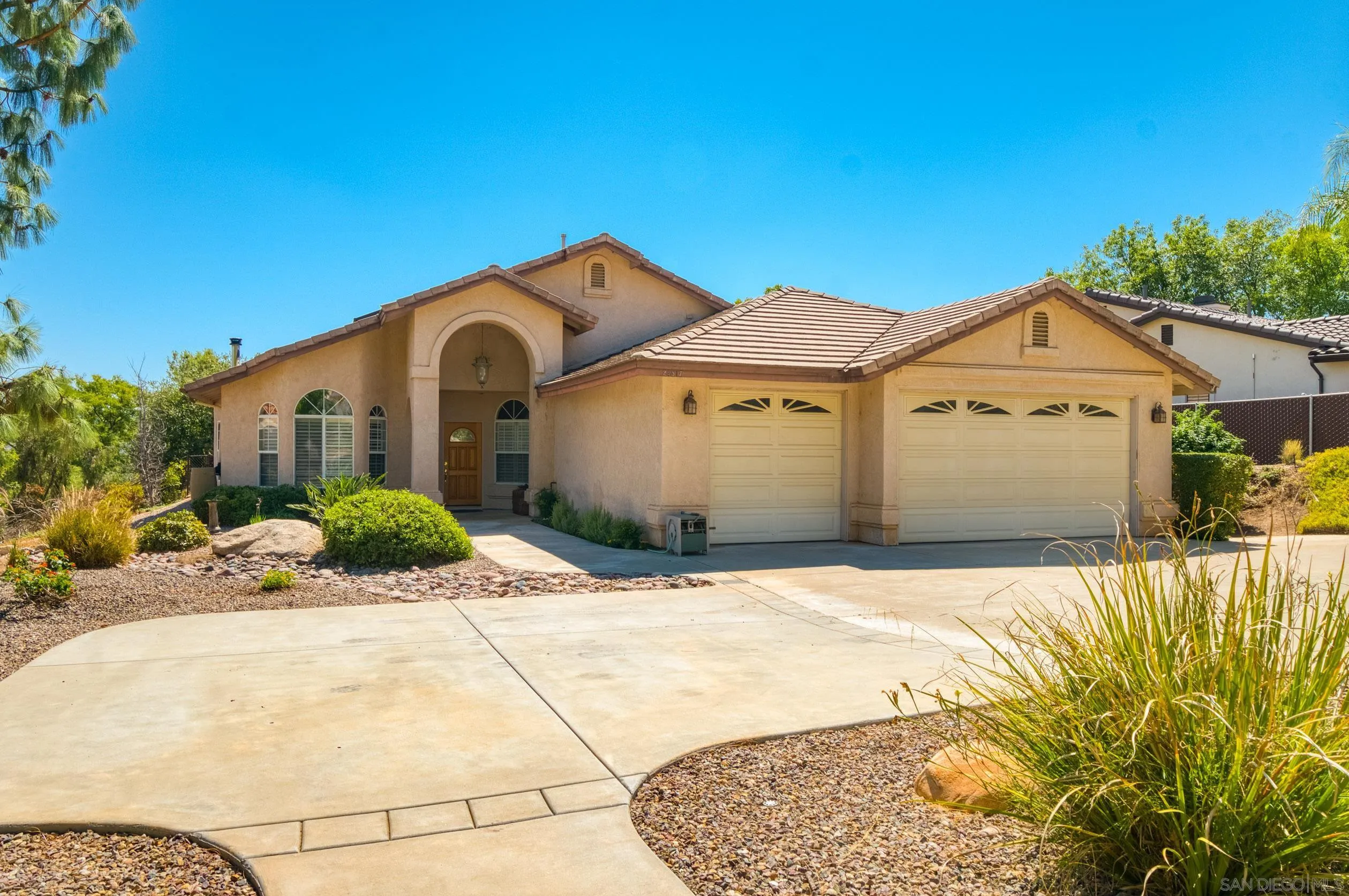 24517 Rutherford Road Ramona, CA 92065 - Photo 1 of 50 a front view of a house with a yard and garage