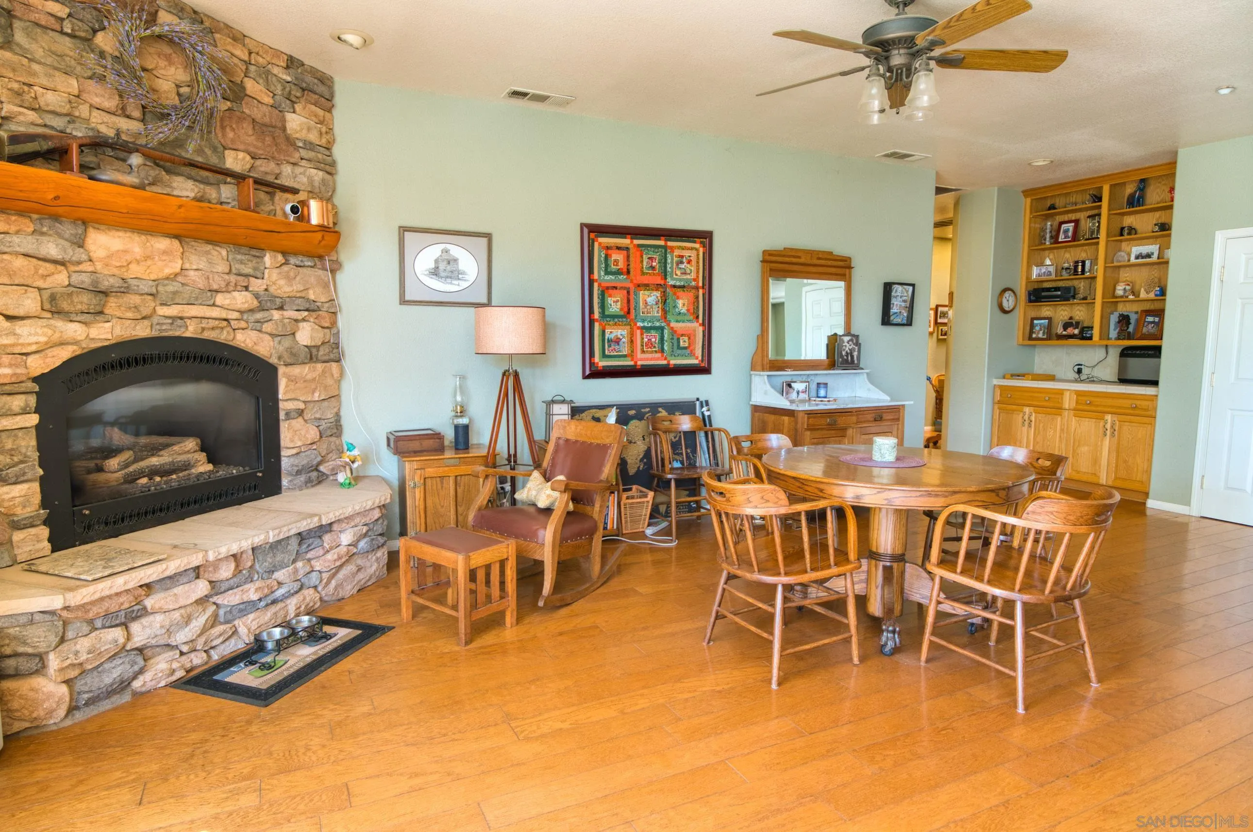 24517 Rutherford Road Ramona, CA 92065 - Photo 11 of 50 a dining room with furniture a flat screen tv and a fireplace