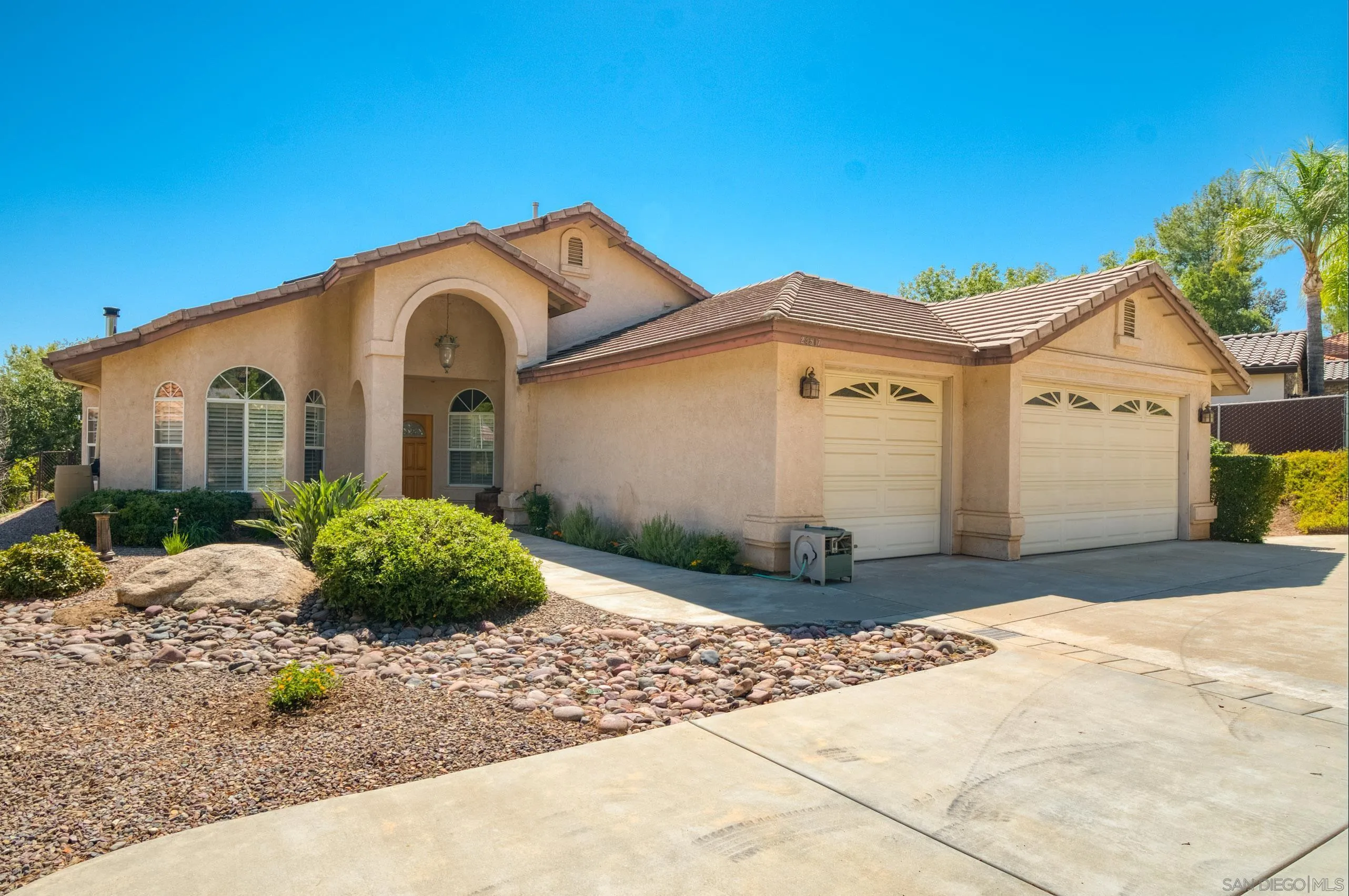 24517 Rutherford Road Ramona, CA 92065 - Photo 3 of 50 a front view of a house with a garden