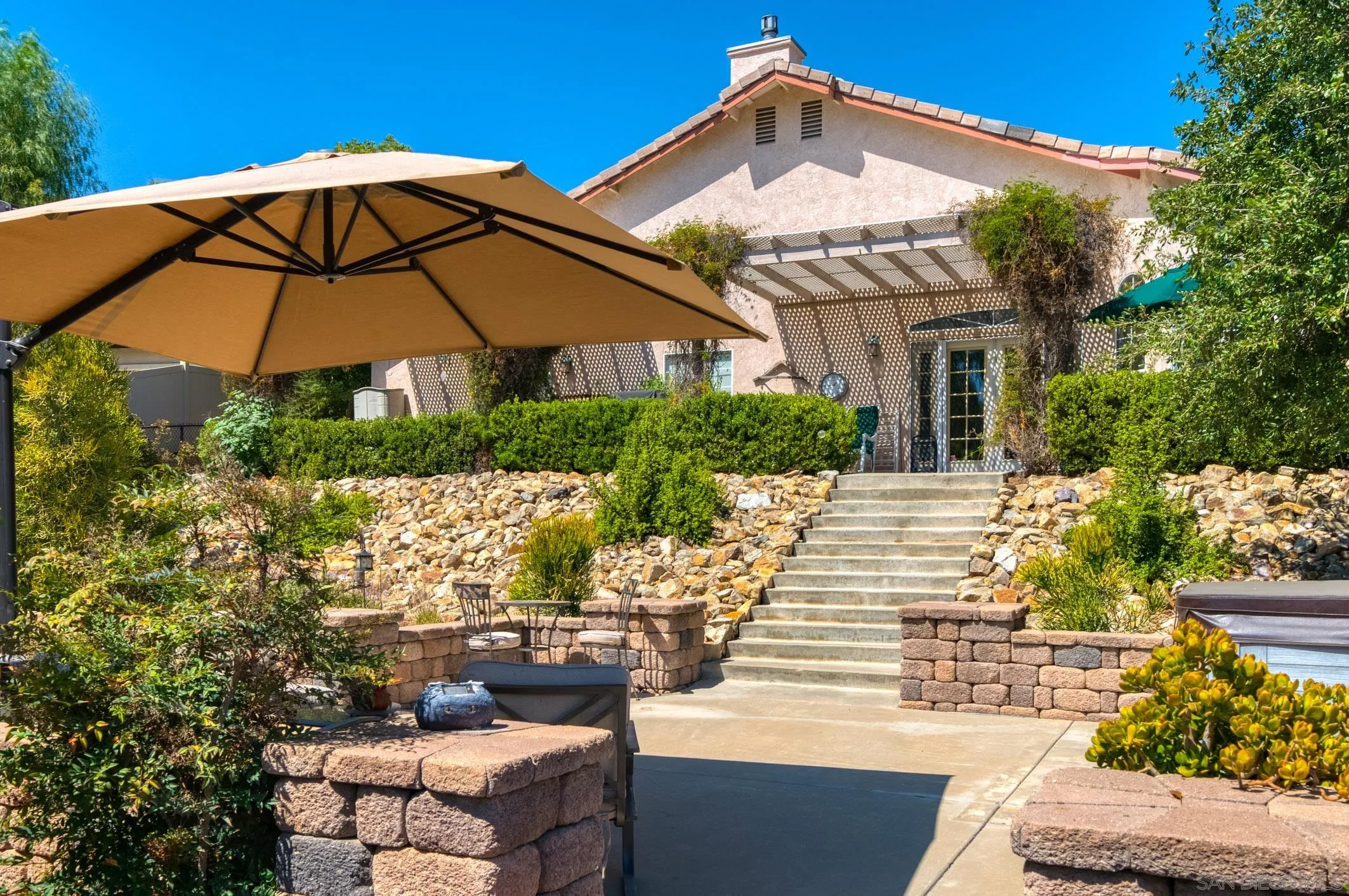 24517 Rutherford Road Ramona, CA 92065 - Photo 36 of 50 a view of a patio with couches table and chairs under an umbrella