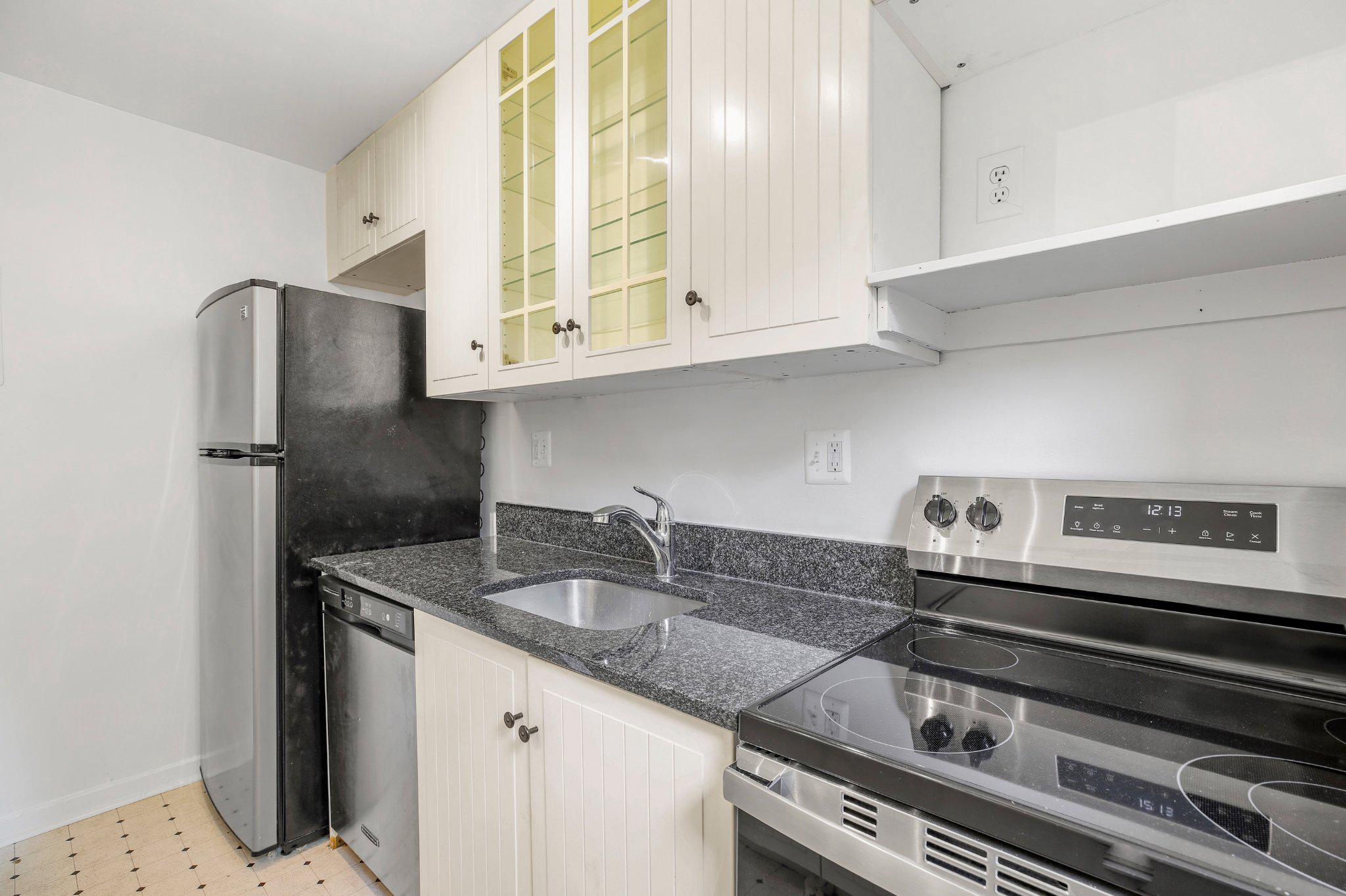 2202 Colston Drive, Unit 102 Silver Spring, MD 20910 - Photo 10 of 38 a kitchen with stainless steel appliances granite countertop a sink and a refrigerator
