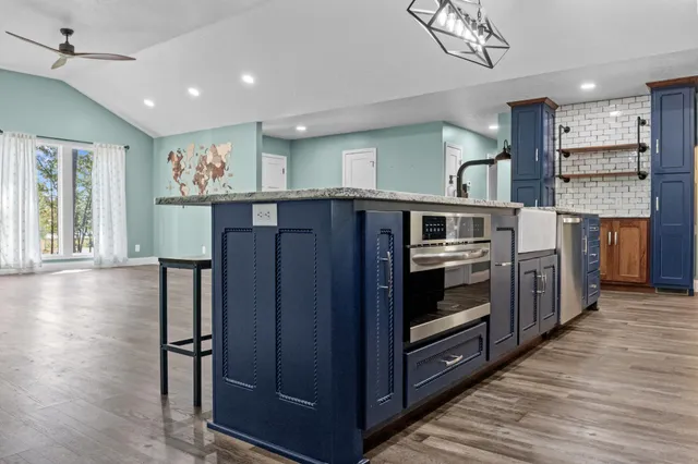 a kitchen with stainless steel appliances granite countertop a stove and cabinets