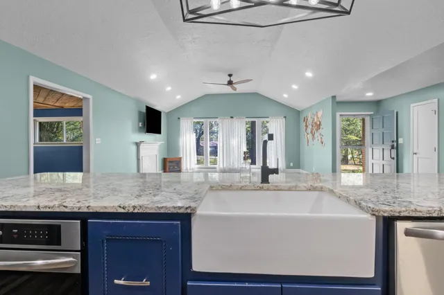a kitchen with a counter space cabinets and wooden floor
