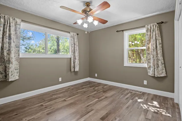 a view of an empty room with wooden floor