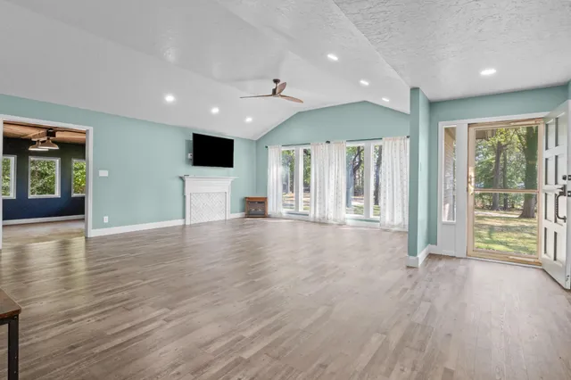 a view of a livingroom with wooden floor and a flat screen tv