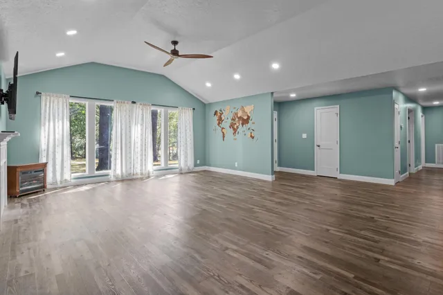 a view of a room with furniture and wooden floor