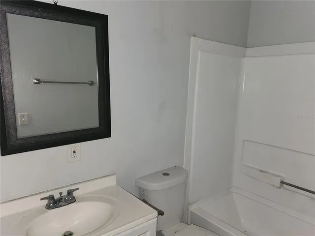 a bathroom with a sink toilet and vanity