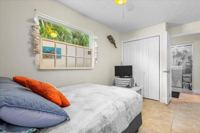 a bathroom with a granite countertop sink mirror vanity and toilet