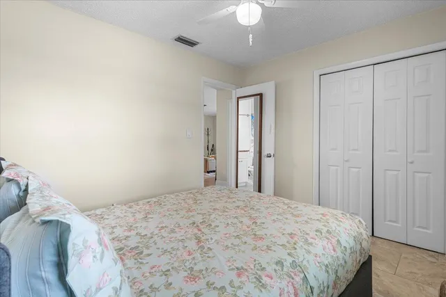 a bathroom with a granite countertop sink a toilet and a shower curtain