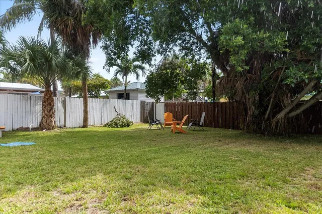 a backyard of a house with table and chairs