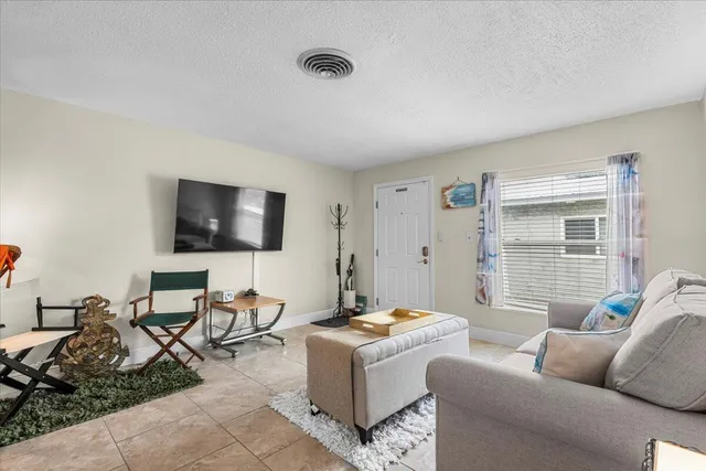 a dining room with furniture a rug and a mirror