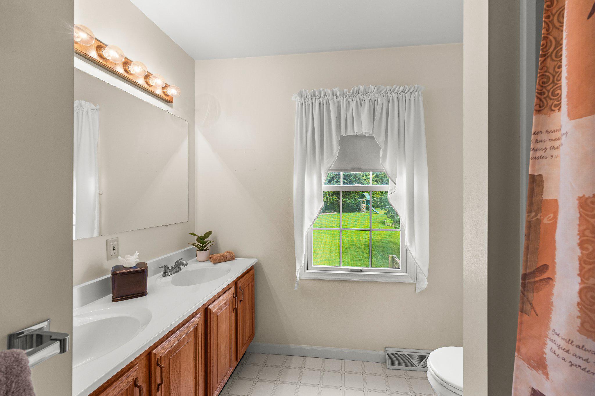 443 Crosswinds Drive Lititz, PA 17543 - Photo 17 of 26 a bathroom with a granite countertop sink and a mirror